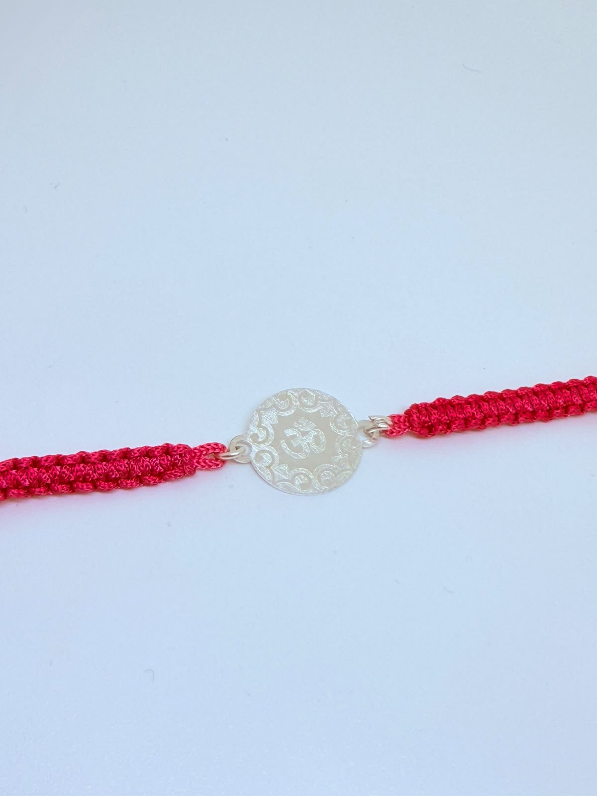 Silver Om Coin Rakhi – Red Thread Designer Rakhi for Brother